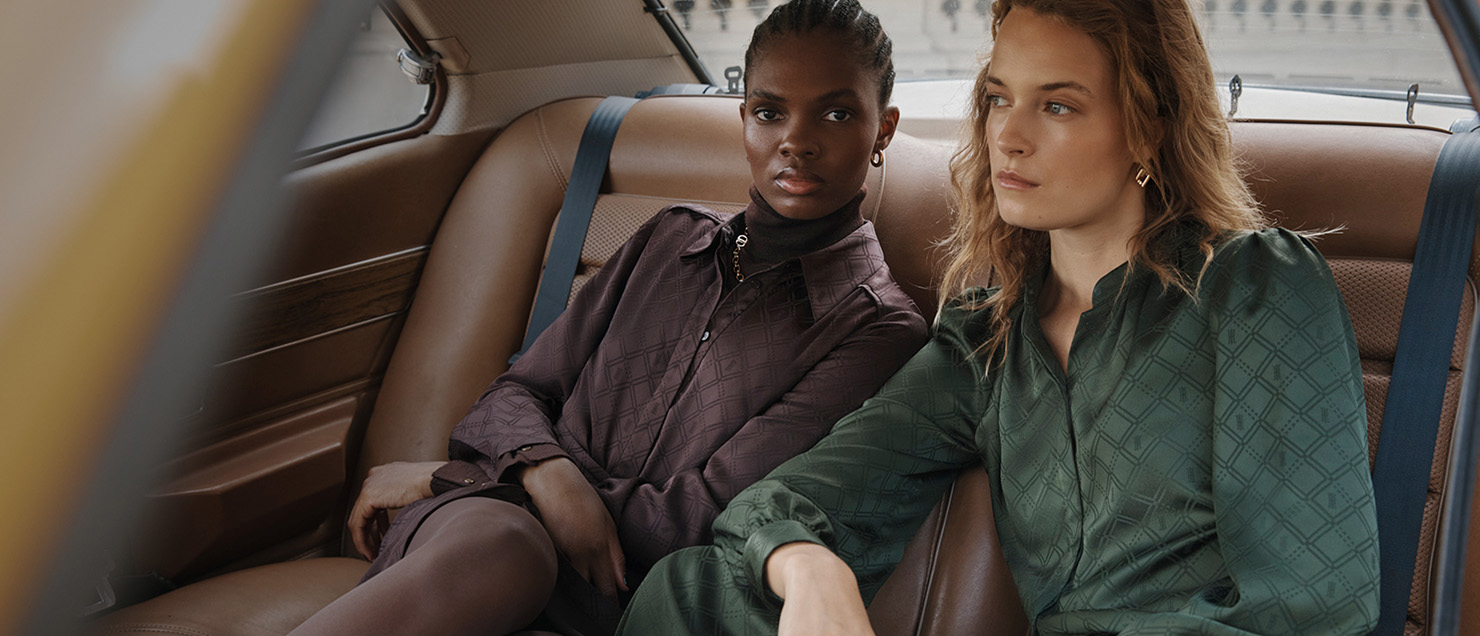 Two models pictured in the back of a car wearing Hobbs outfits.