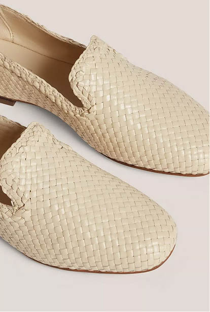 A woman wearing a Hobbs dress.