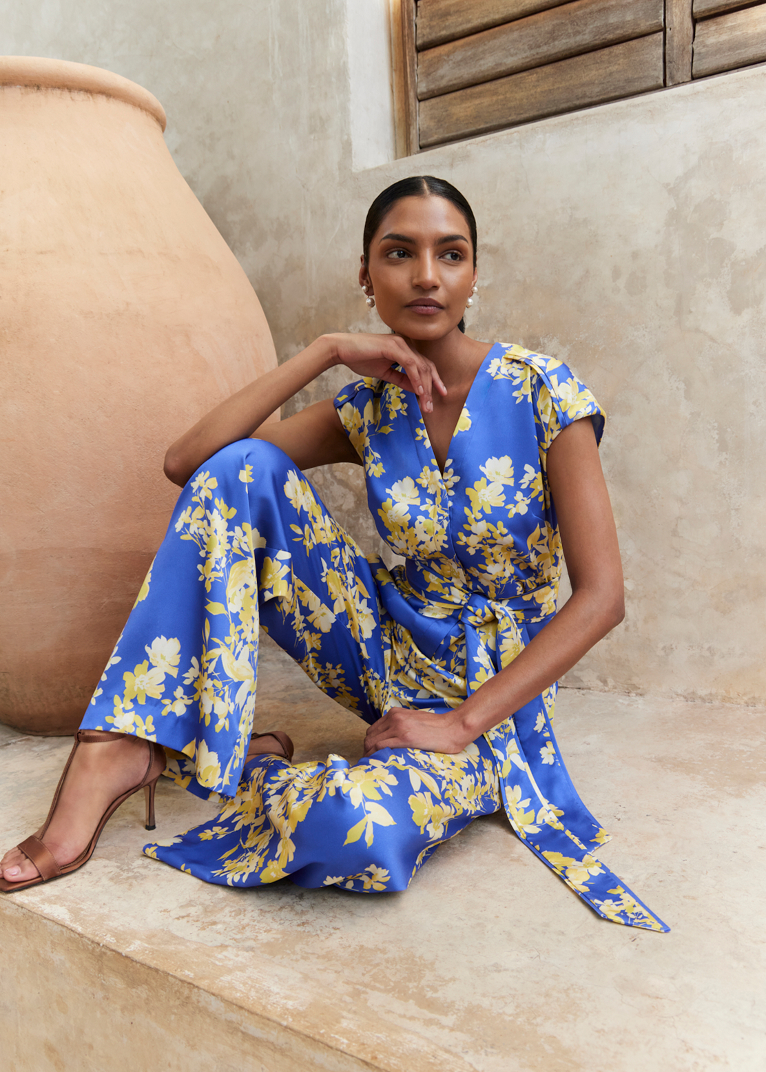 A woman wearing a Hobbs occasion jumpsuit.