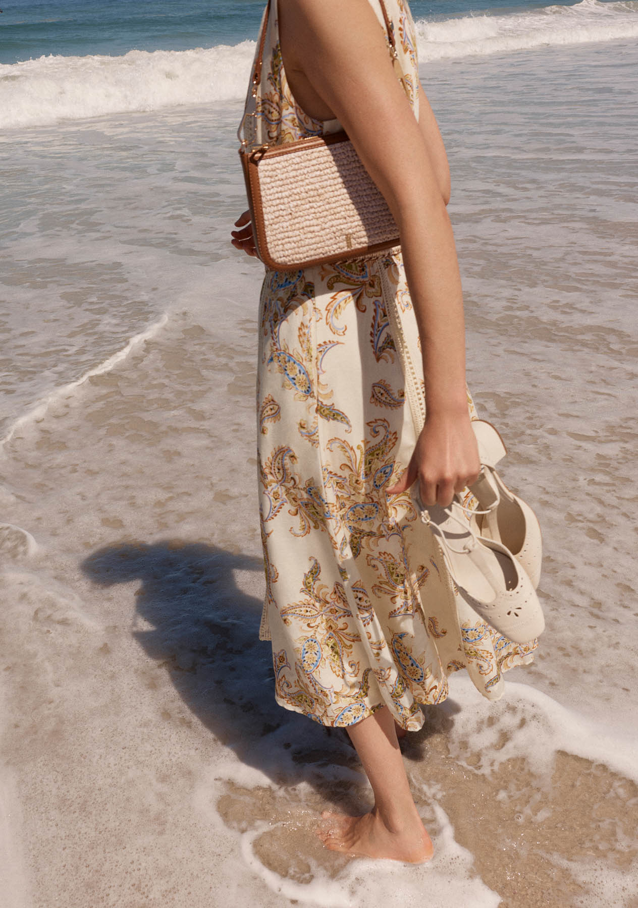 A woman wearing a Hobbs linen paisley dress.