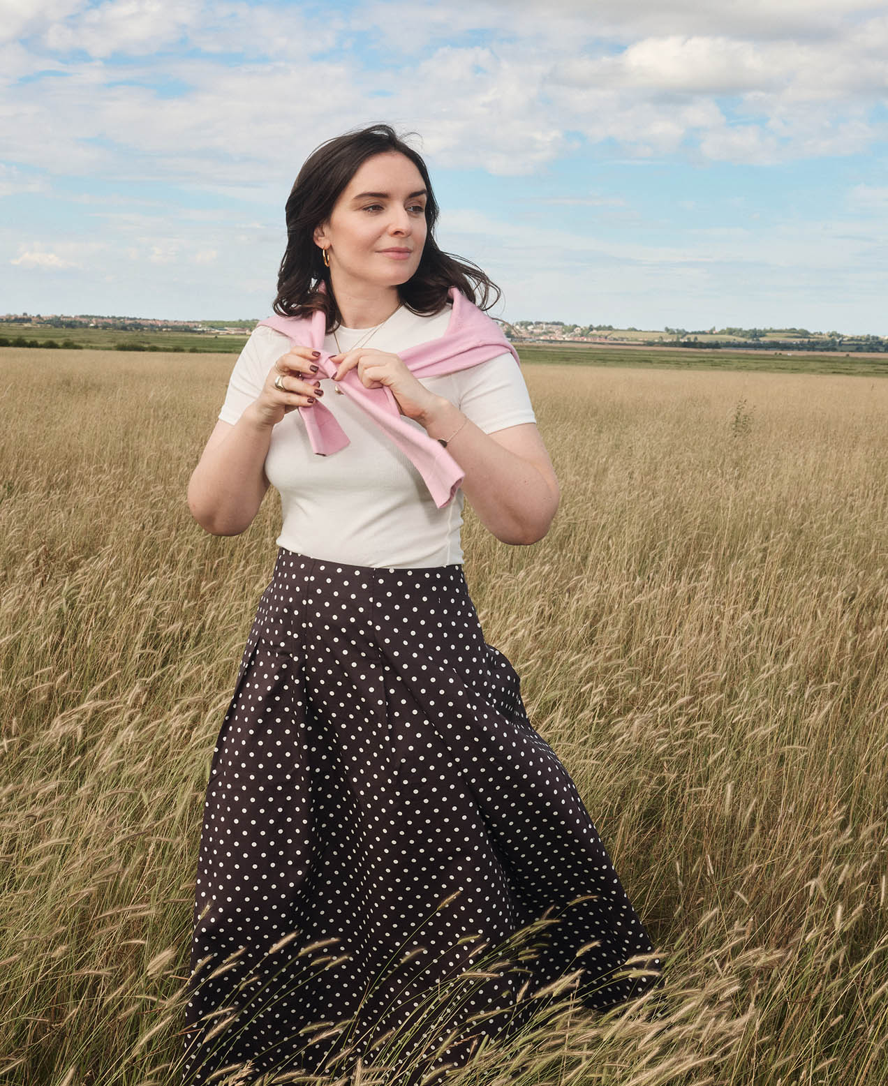 A woman wearing a Hobbs white summer dress