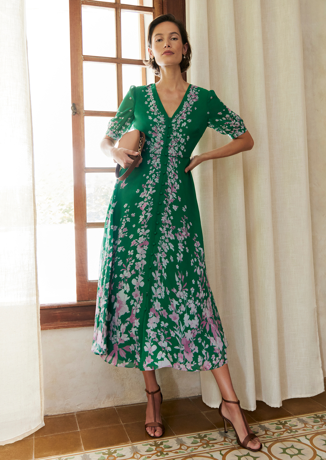 An image of a model wearing a petite Hobbs floral dress.