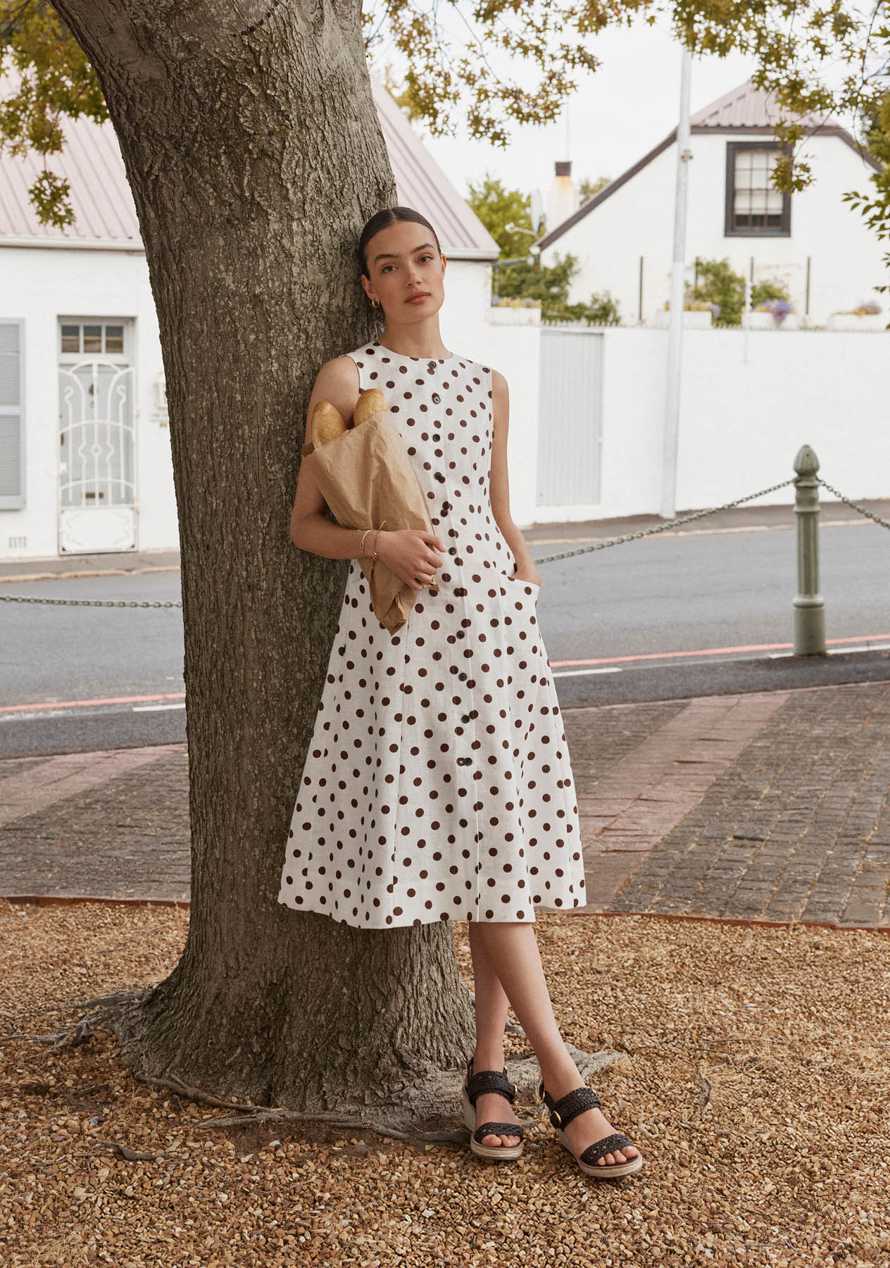 A woman wearing a polka dot Hobbs dress.