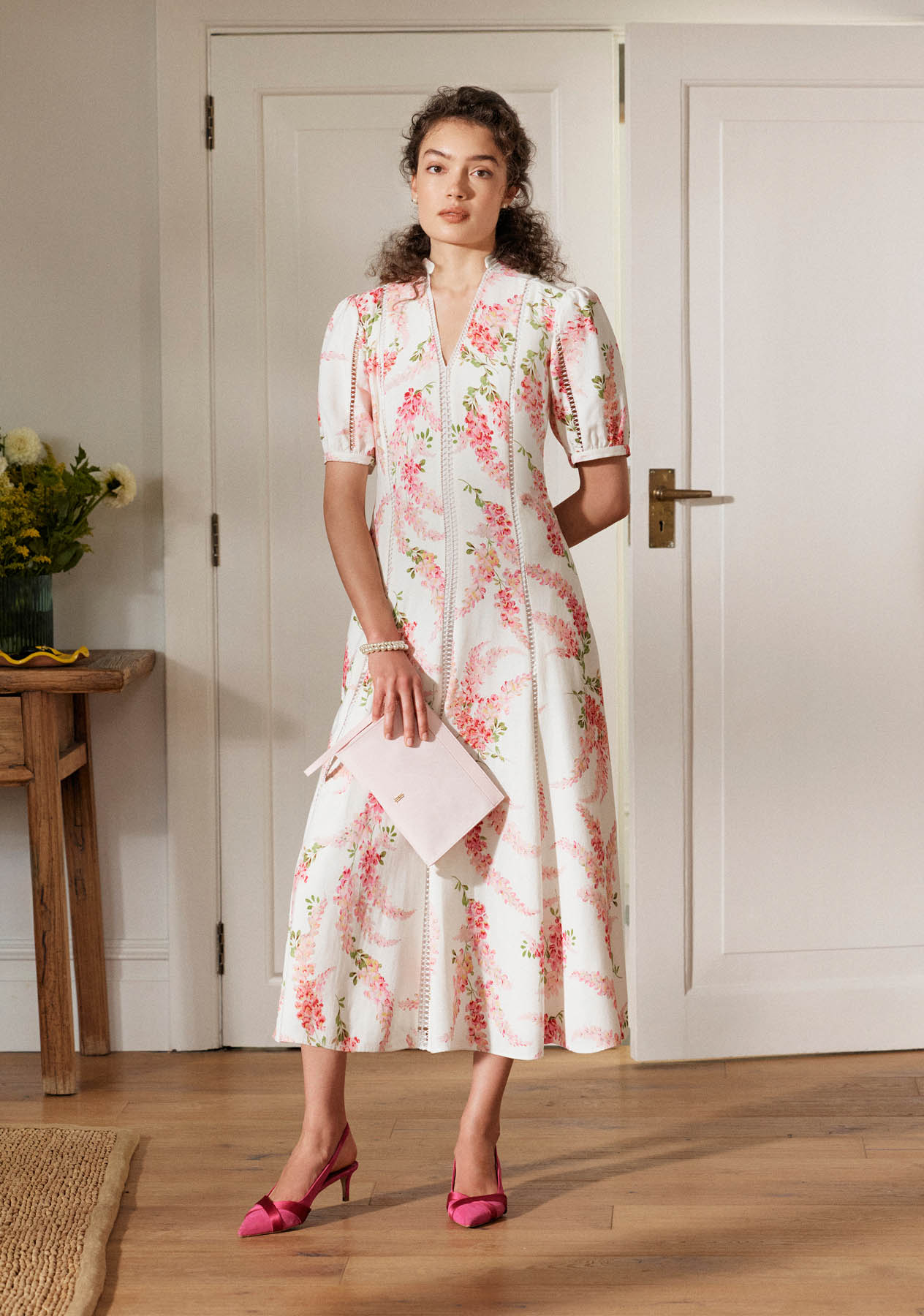 A woman wearing a Hobbs linen occasion dress.