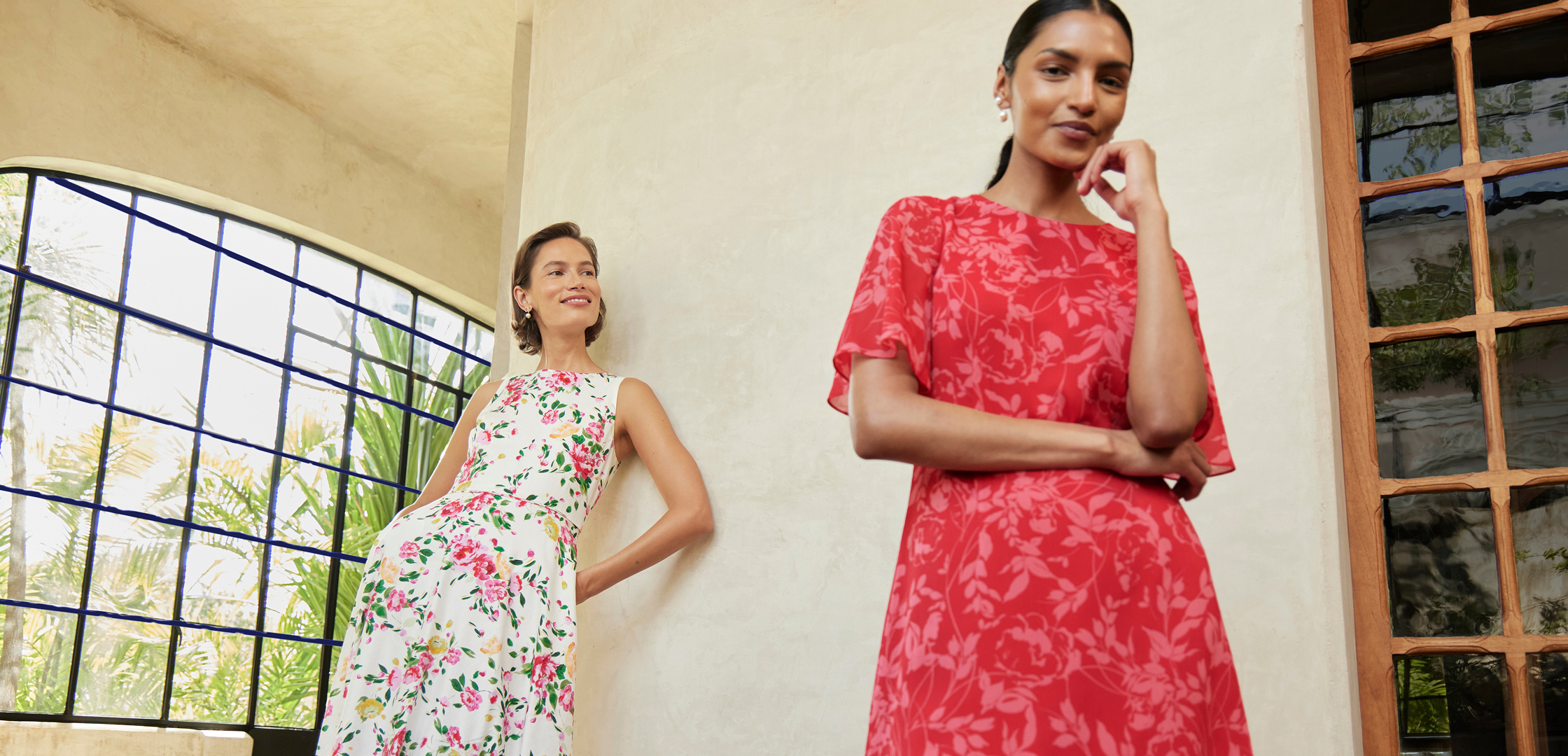 An image of two models wearing Hobbs floral occasion dresses.