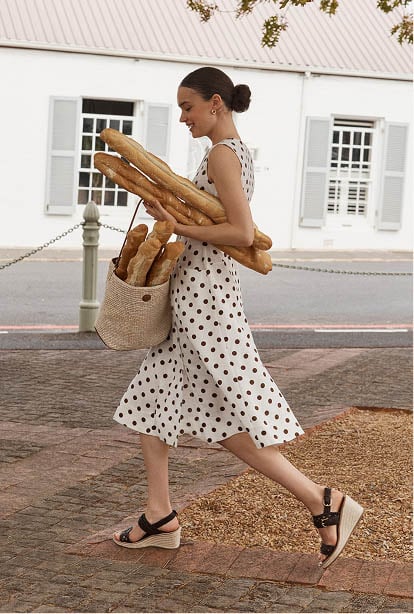 A woman wearing a polka dot Hobbs dress.