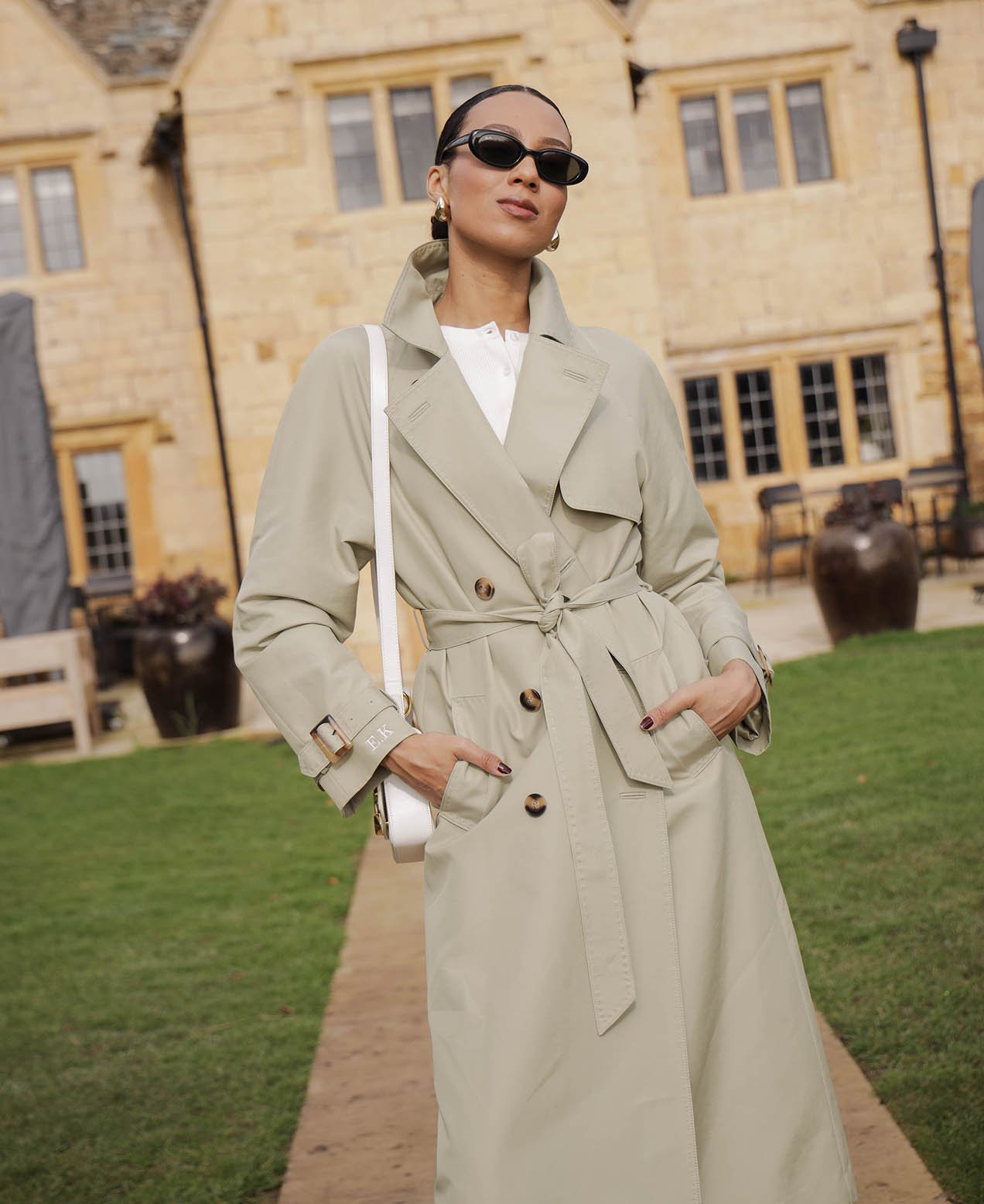@whatevawears wearing the sage green Riley trench coat.