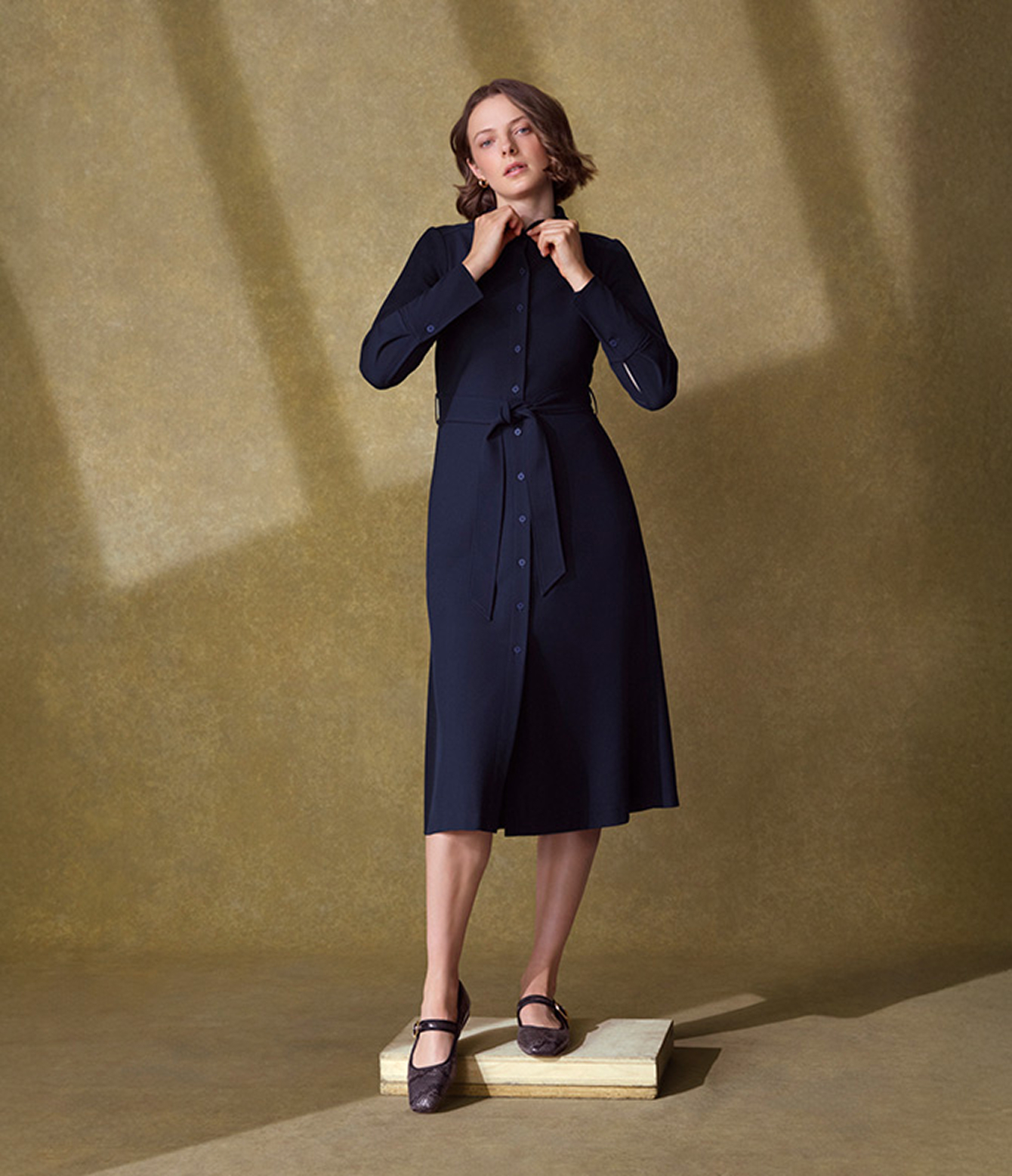 A woman wearing a Hobbs blue shirt dress.