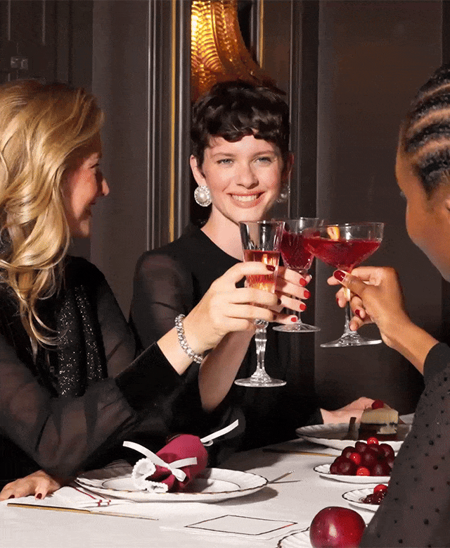 Women wearing black Christmas party outfits.