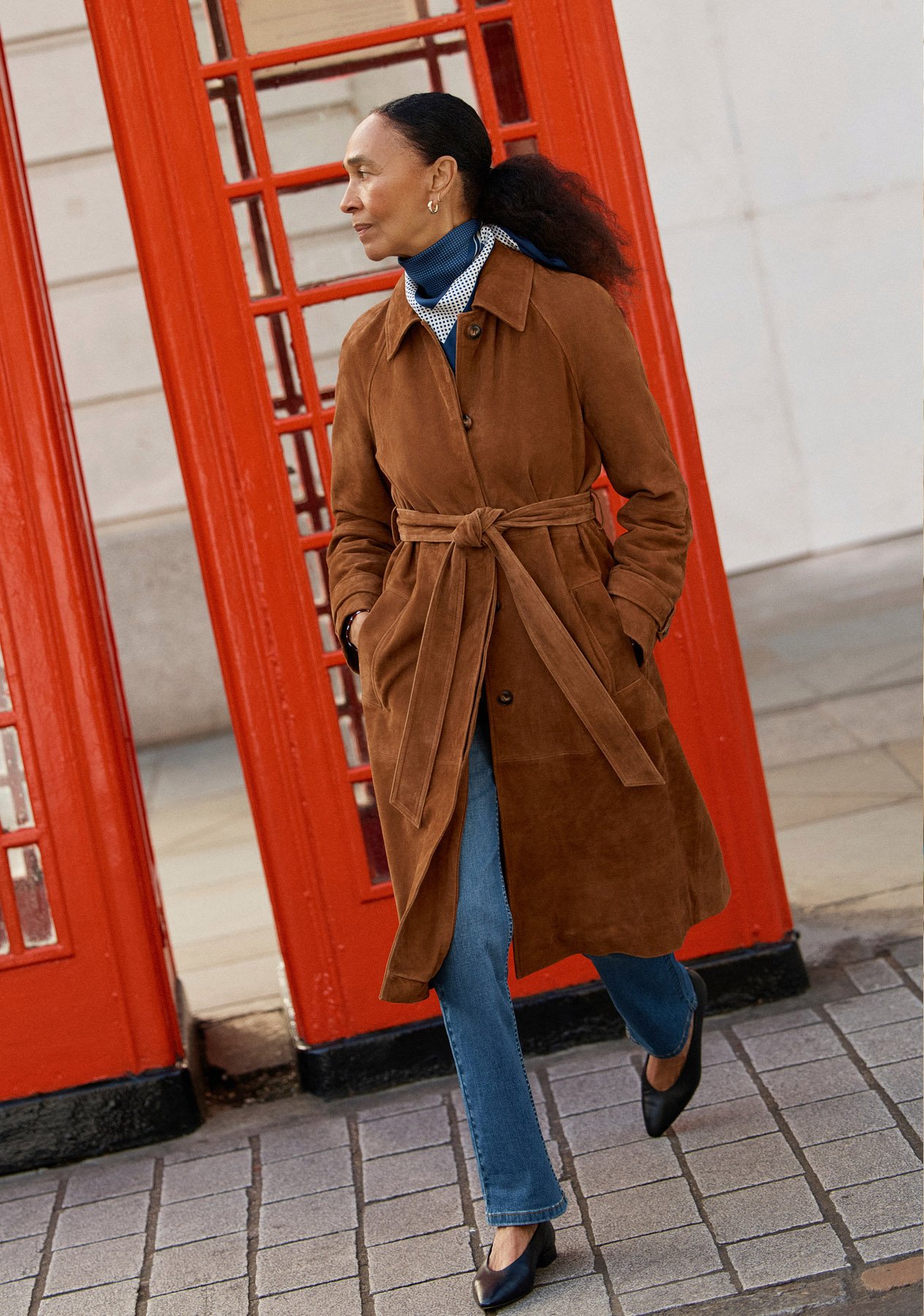 Women wearing different trench coats.