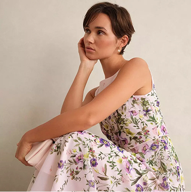 A woman wearing a blush pink occasion outfit.