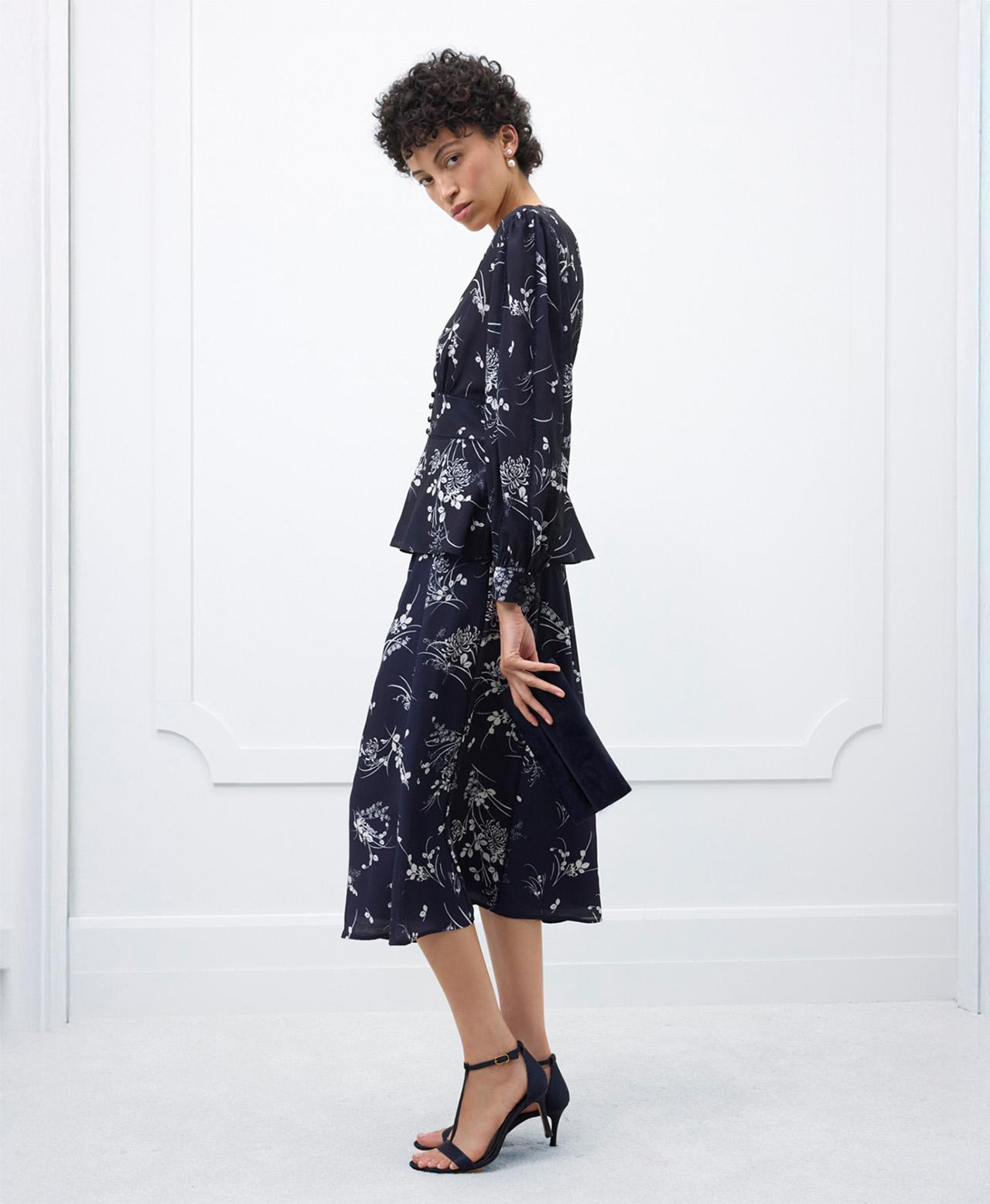 A woman wearing a contemporary, floral, Hobbs occasion co-ord