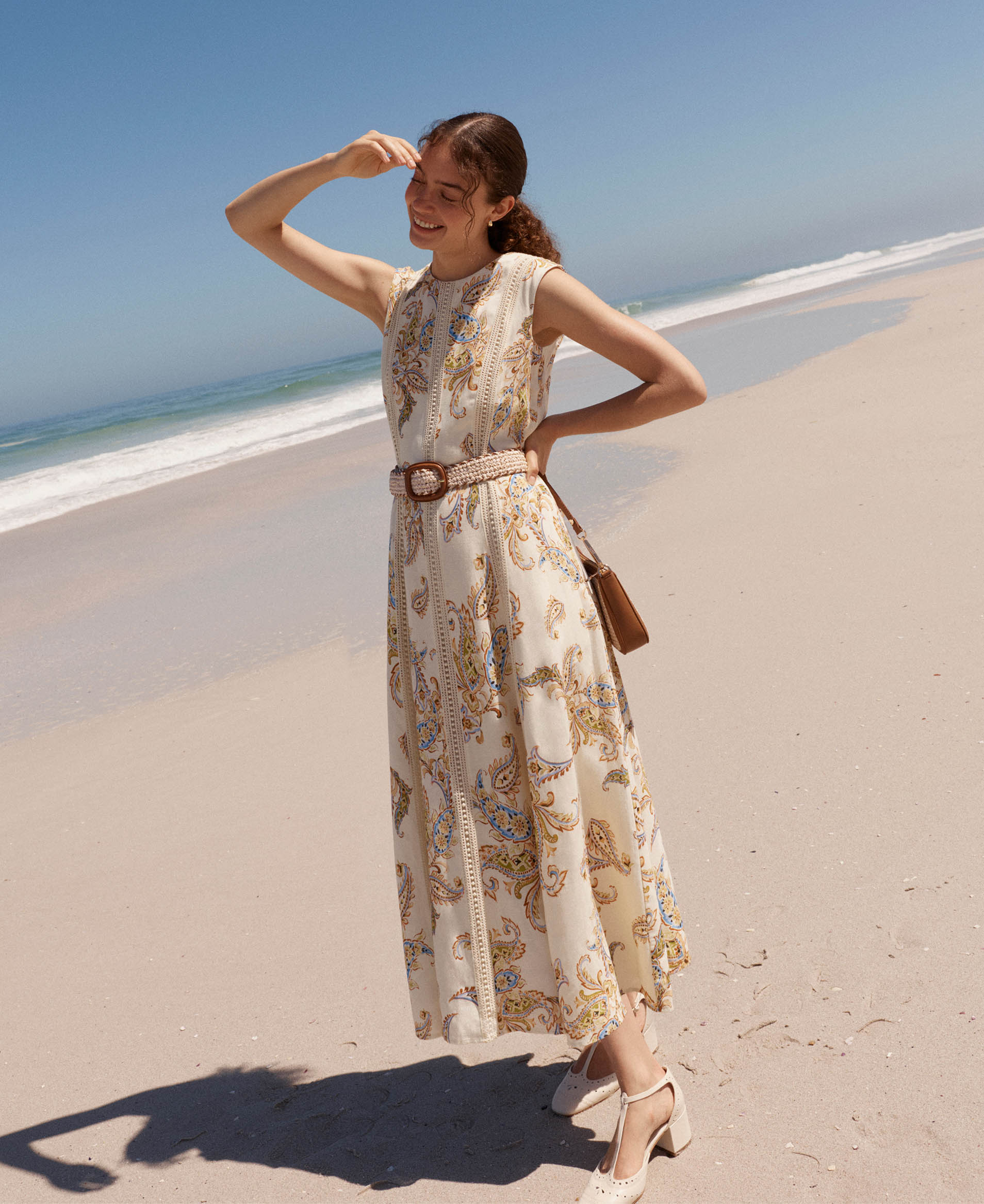 A woman wearing a Hobbs summer dress.