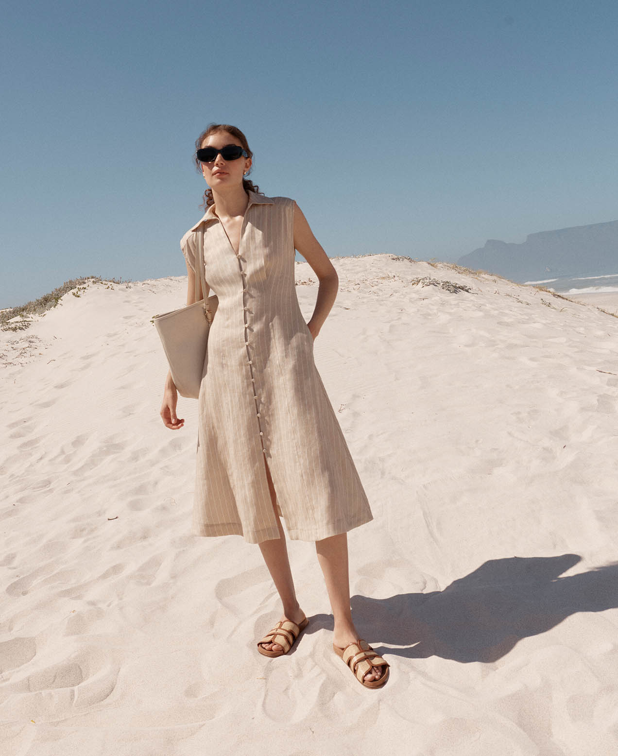 A woman wearing a Hobbs broderie tunic dress