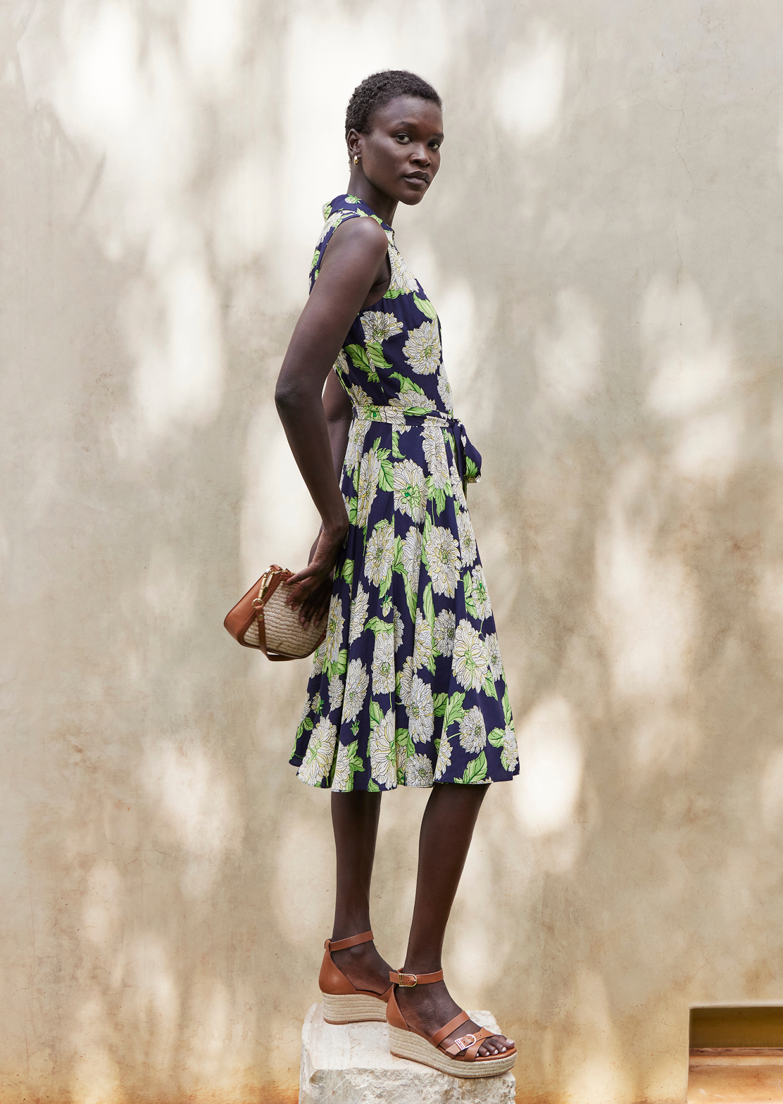 A woman wearing a floral Hobbs summer dress.