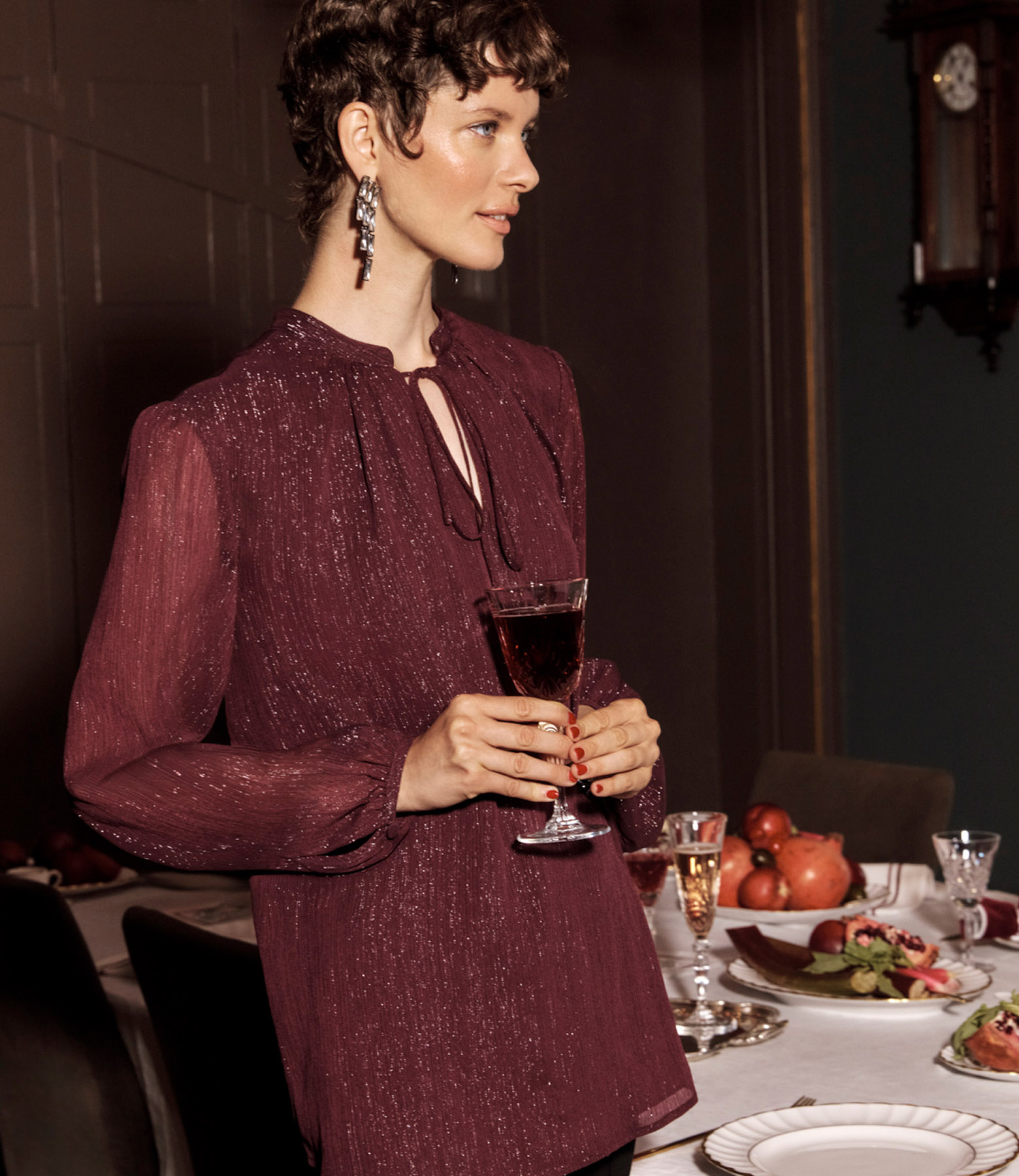 A woman wearing a metallic blouse.