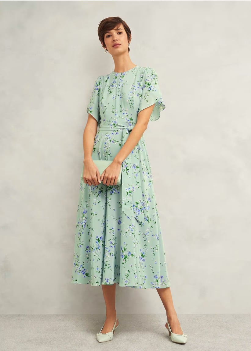 A gallery of four images of models wearing occasion floral midi dresses and coordinating accessories.