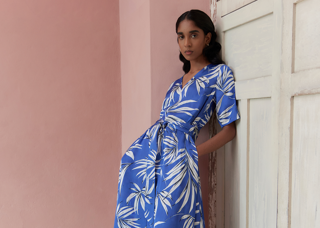Model photographed in a blue dress.