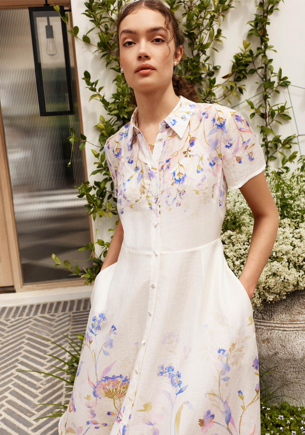 A woman wearing a floral shirt dress.