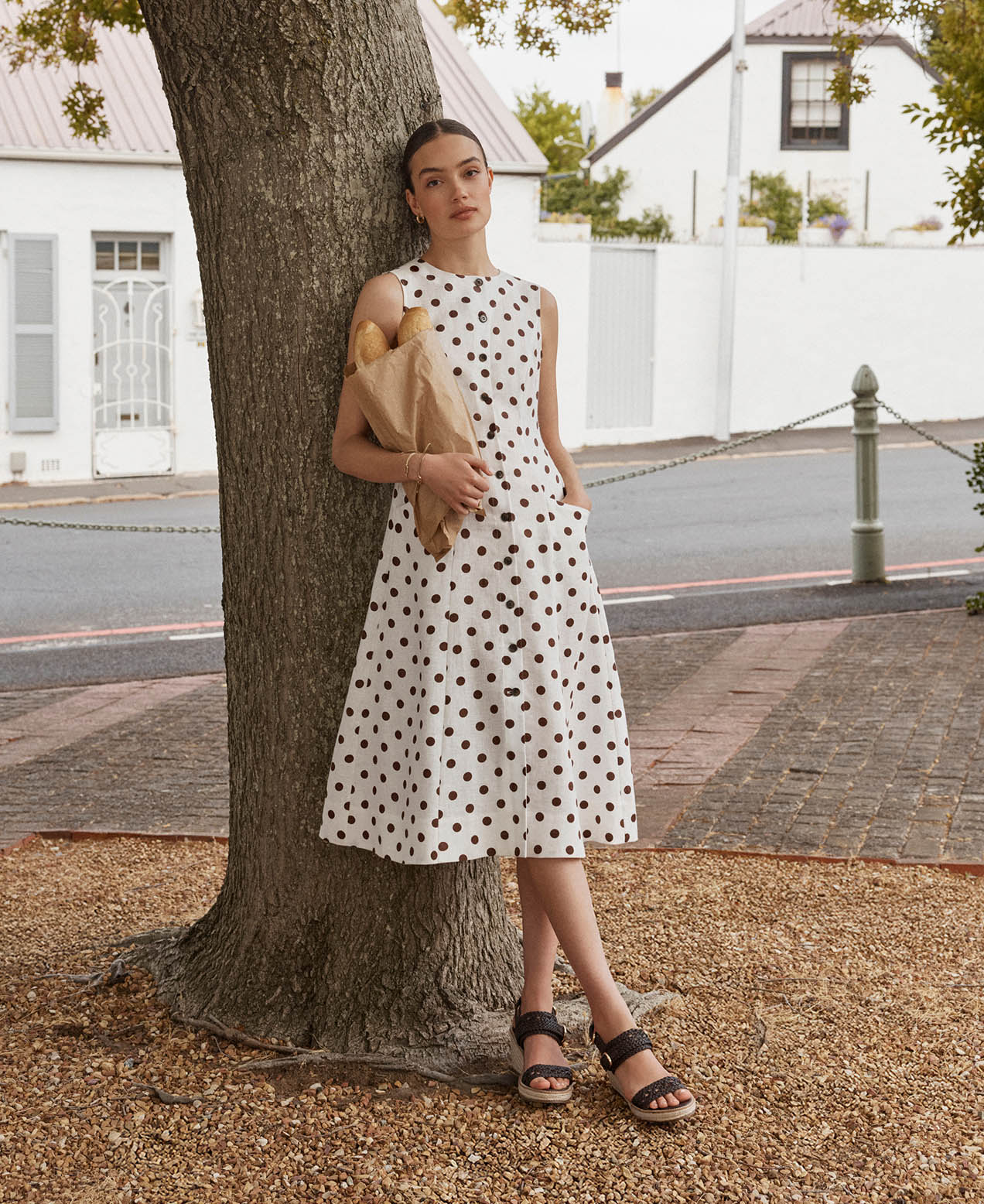 A woman wearing a polka dot linen dress.