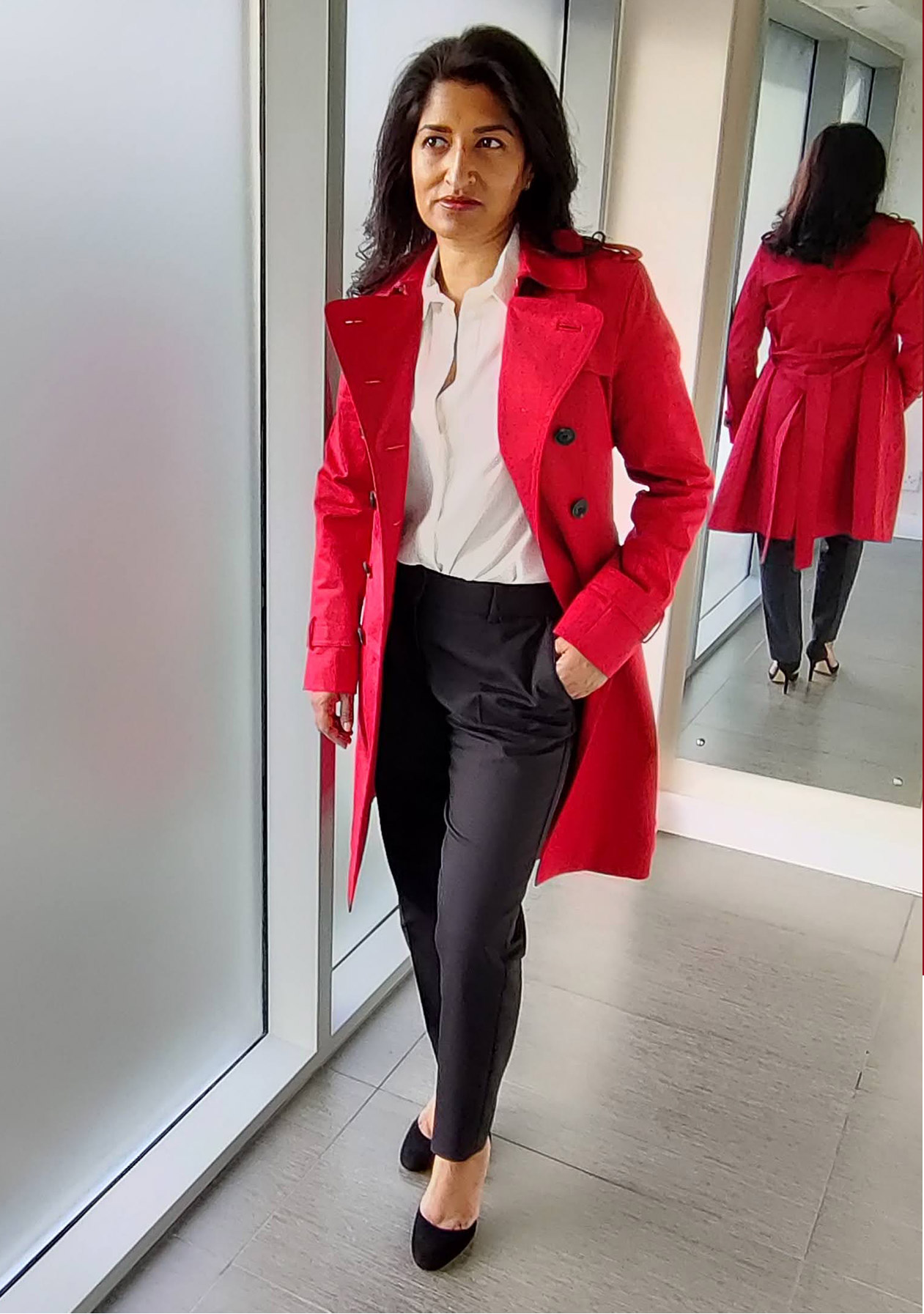 Photographed at home, fashion blogger Monika Mandal wears Hobbs petite red Saskia trench and Quin navy trousers.