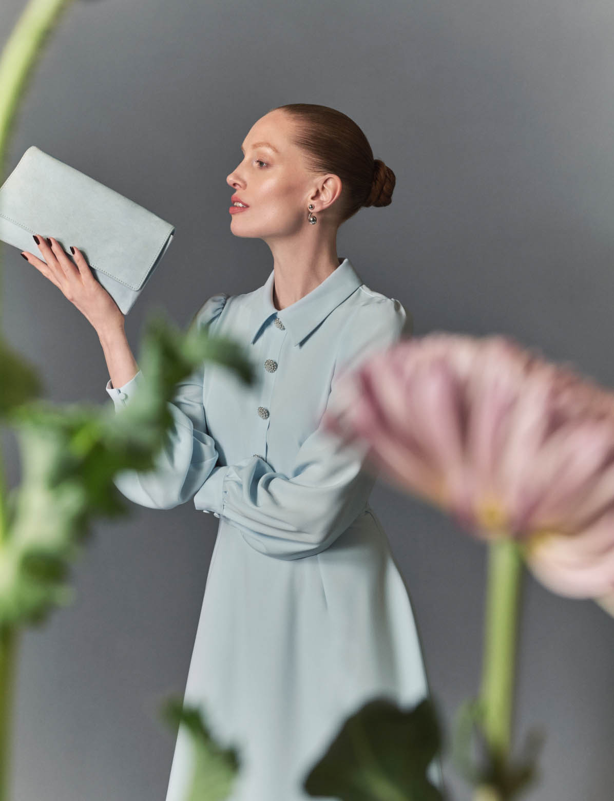 MODEL WEARING LONG SLEEVE PALE BLUE DRESS