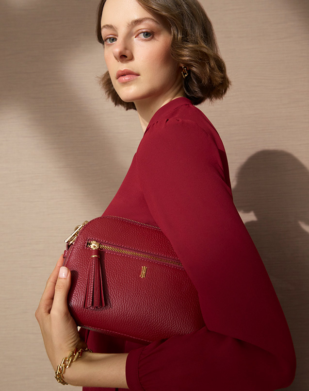 A woman wearing a Hobbs leather bag.