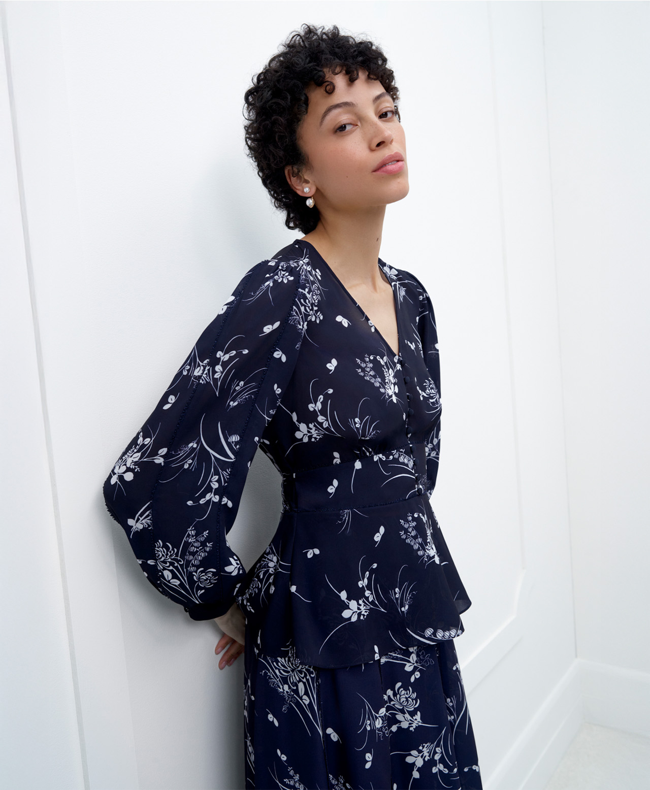 A woman wearing a contemporary, floral, Hobbs occasion co-ord
