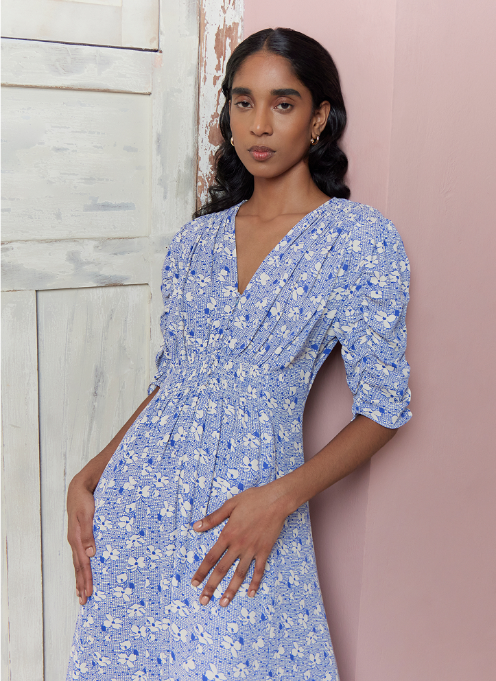 Model photographed in blue dress.