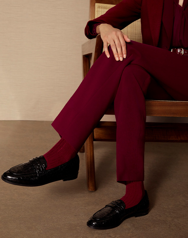 A woman wearing Hobbs leather loafers.