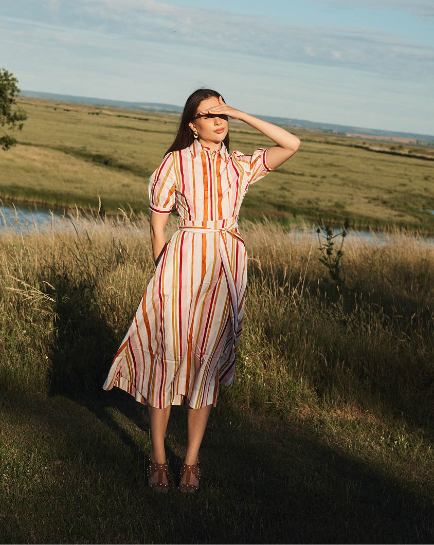 A woman wearing a Hobbs ditsy floral dress.