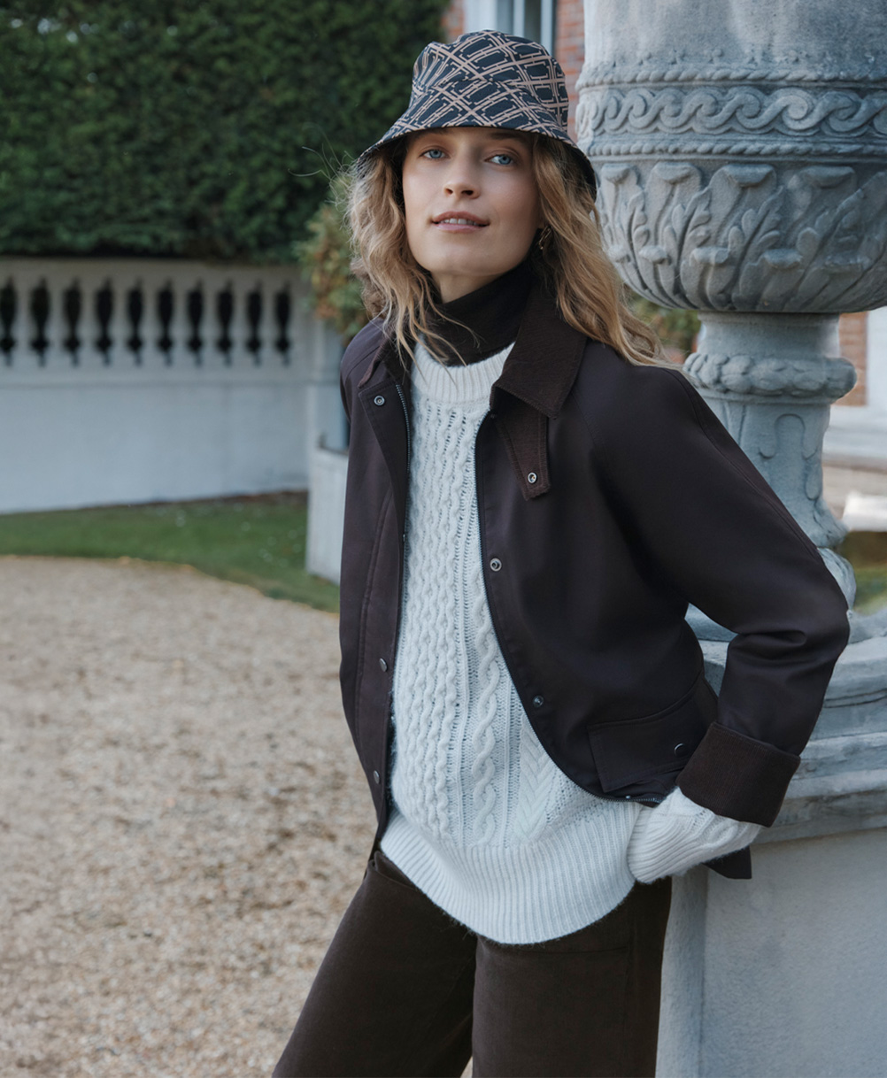 A woman wearing a Hobbs chocolate barn jacket.