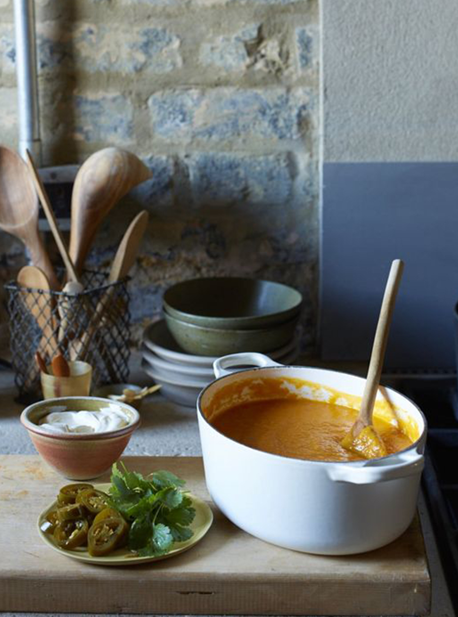 Casserole dish containing soup on a kitchen sideboard.