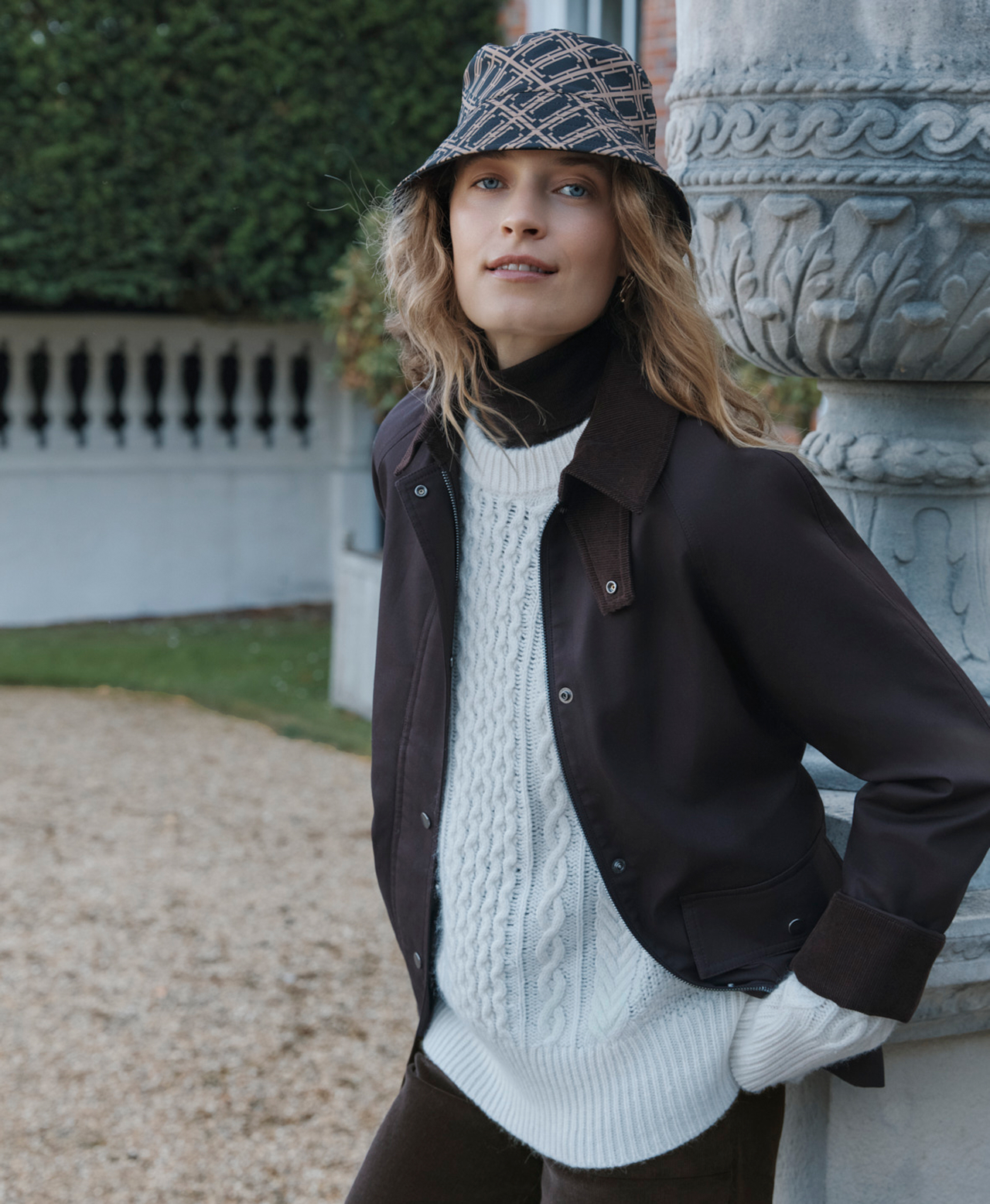 A woman wearing Hobbs coats and jackets.