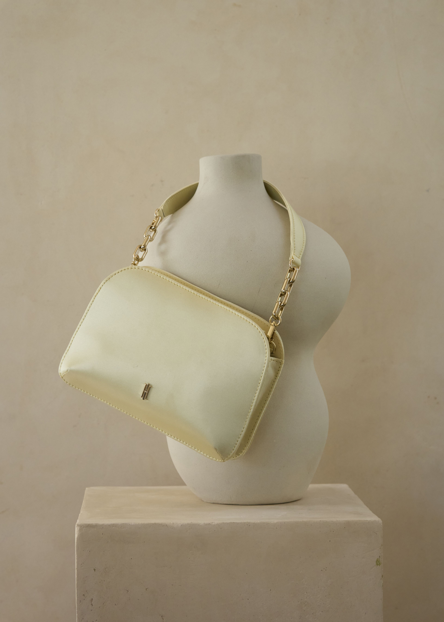 A buttermilk Hobbs satin bag and matching buttermilk Hobbs satin shoes.
