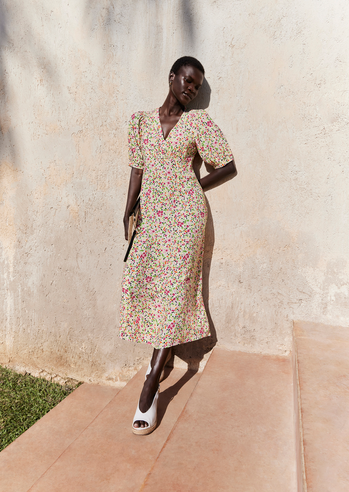 A collage of two images showcasing a model wearing a Hobbs’ ditsy print floral dress.