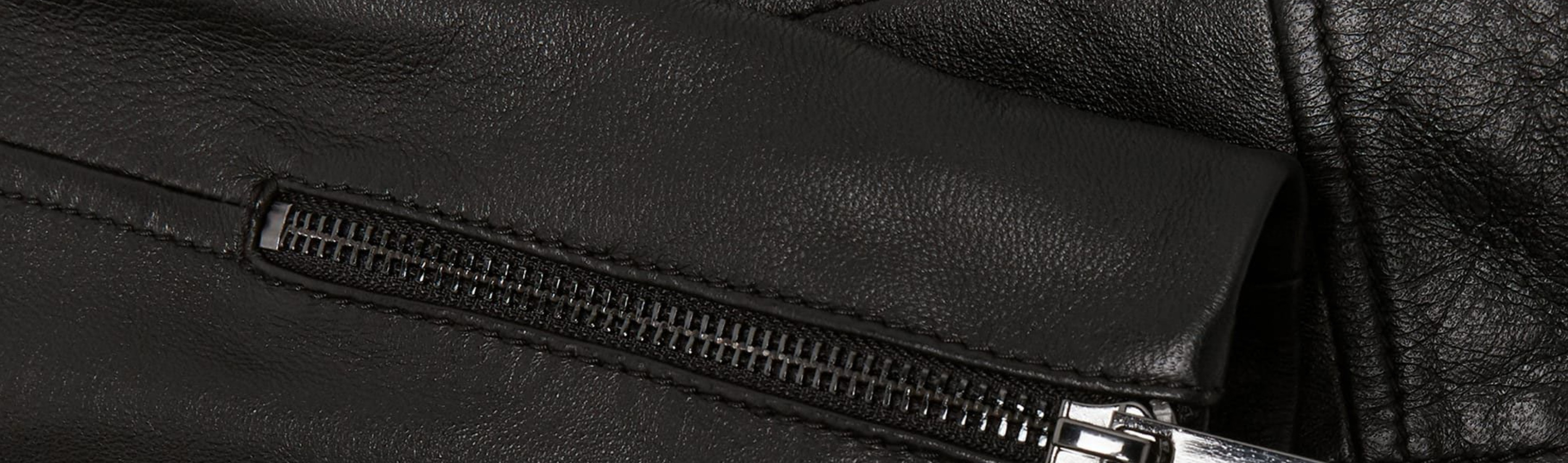 A close-up of the cuff of a Hobbs leather skirt.